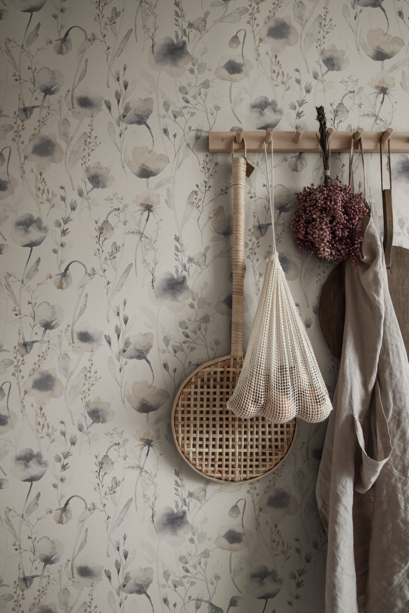 a wall with flowers and a bag on it