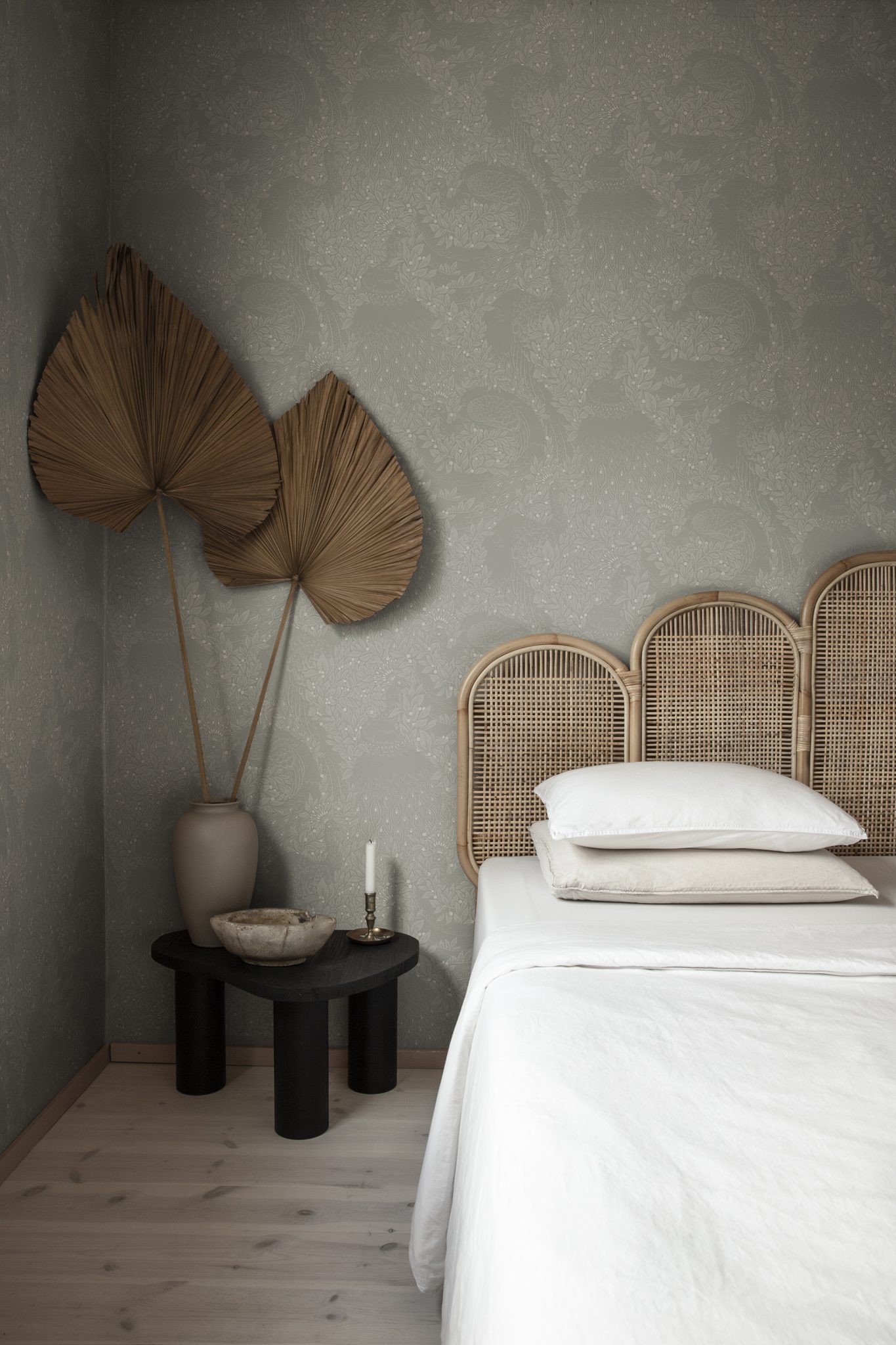 a bed with a headboard and two vases