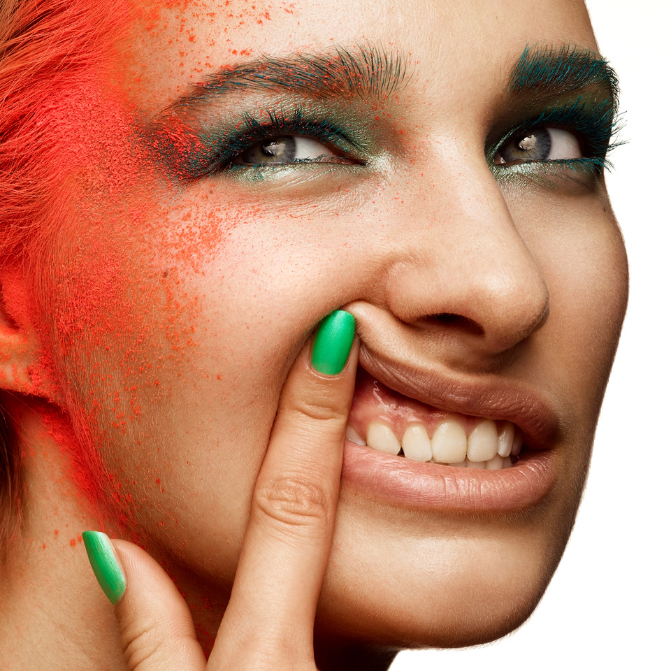 a woman with green and red makeup