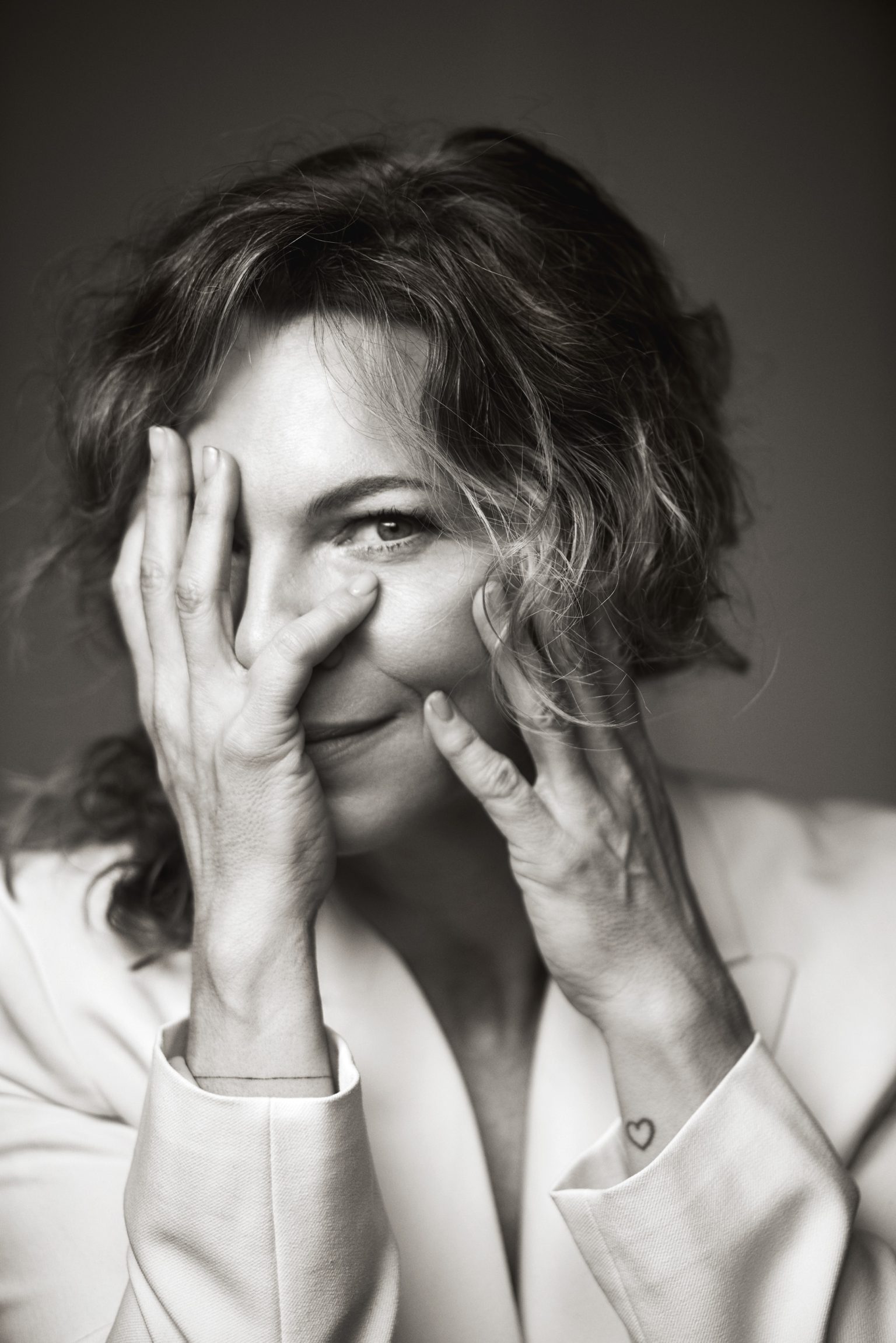 a woman with her hands over her face