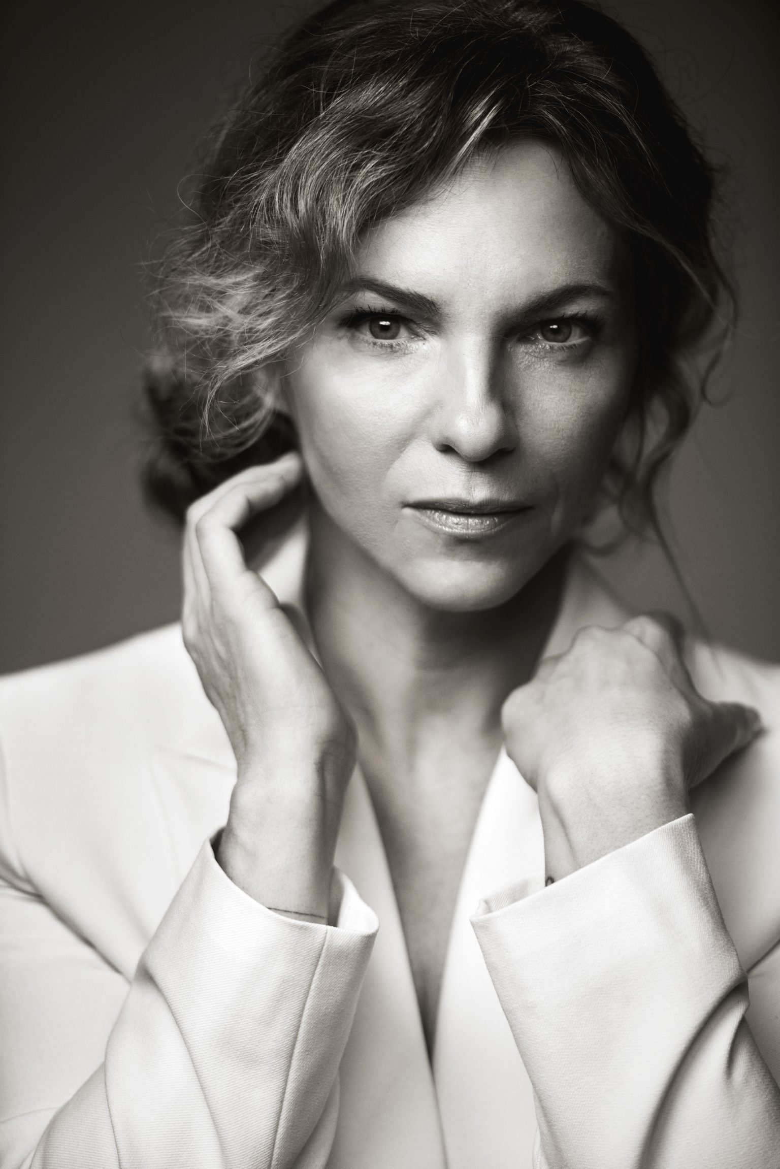 a woman in a white suit