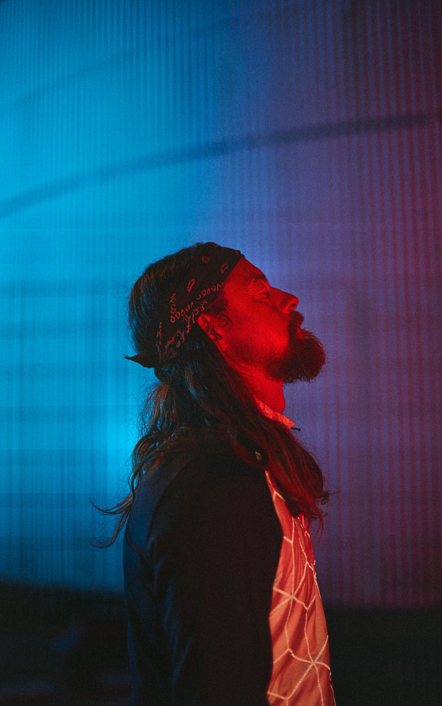 a man with long hair and a bandana