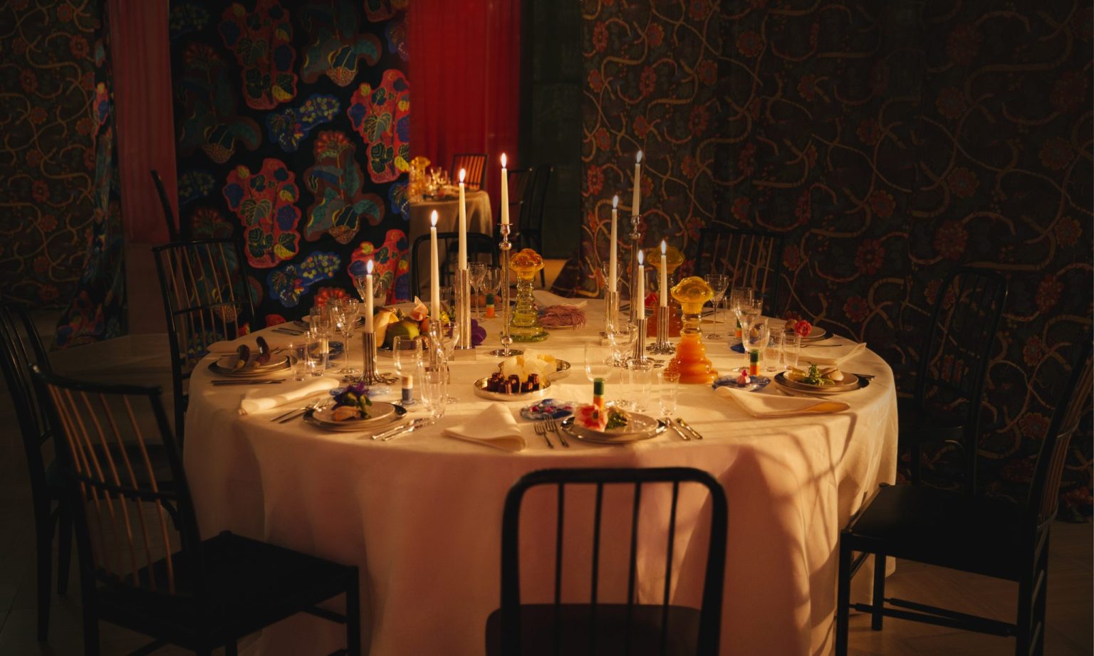 a table with a white tablecloth and candles on it