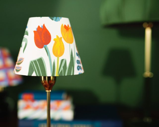 Lampshade with tulips pattern on a brass lamp.