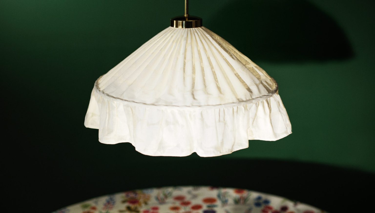 a white lamp shade with a flowered table
