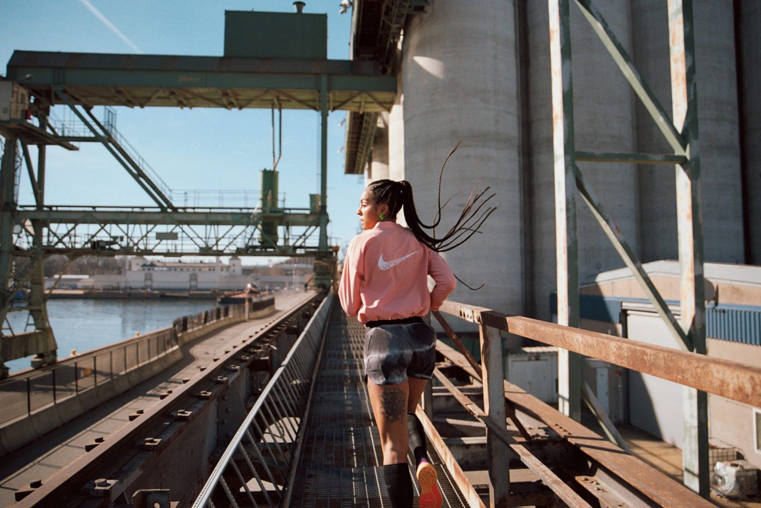 a woman running on a metal railing