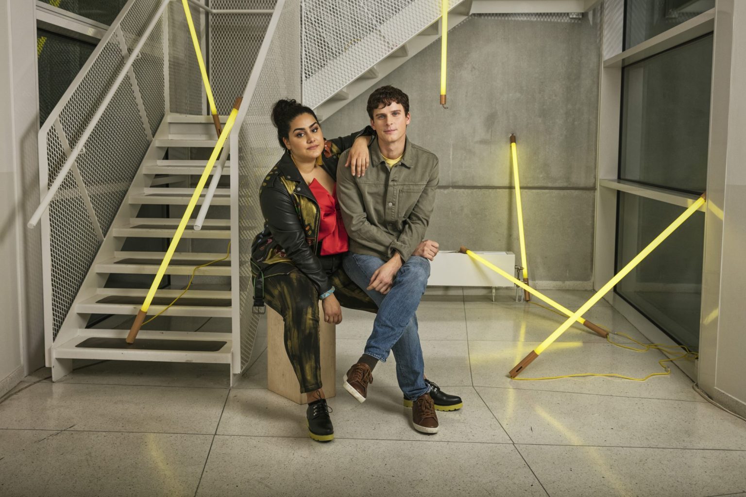 a man and woman sitting on a bench