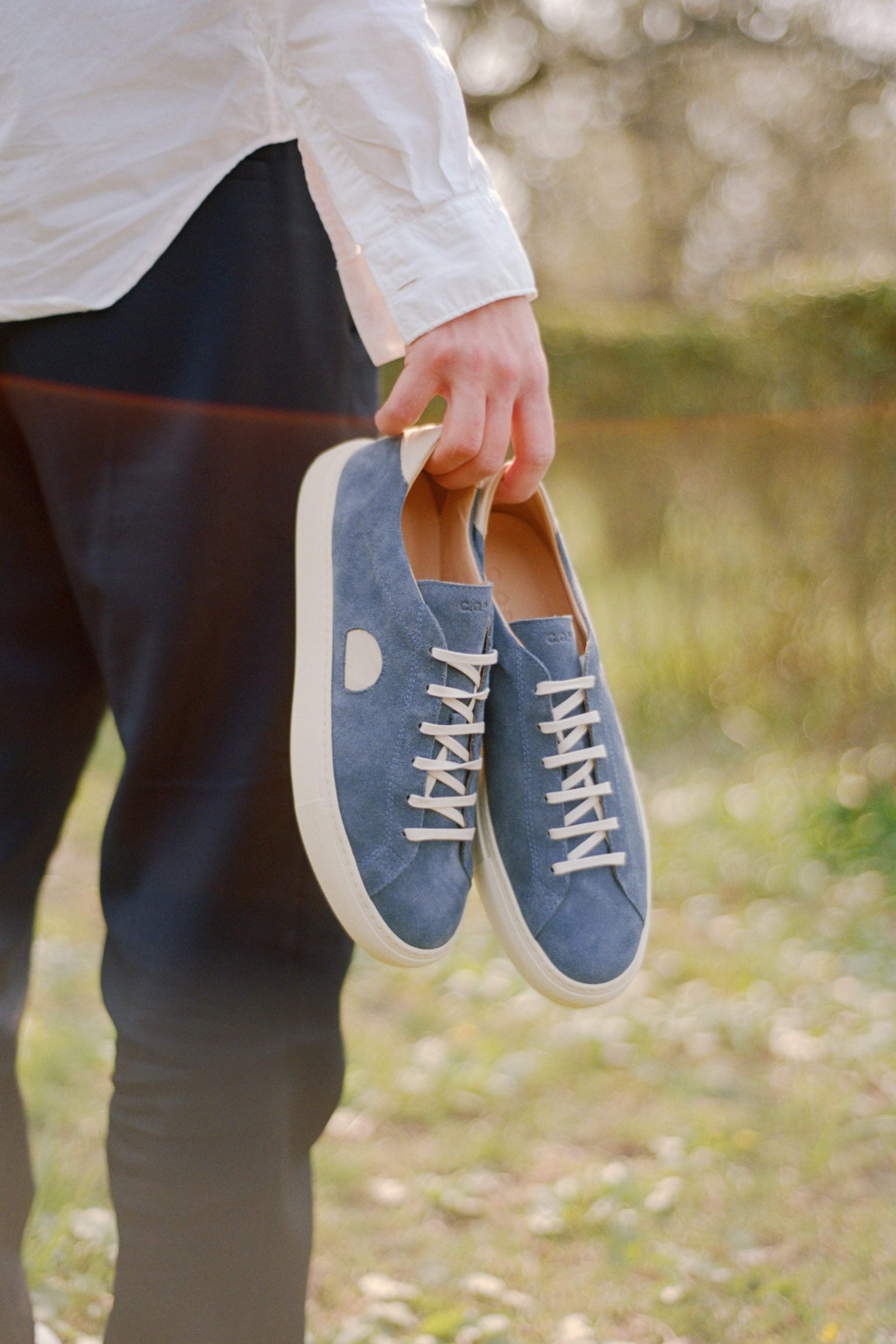a person holding a pair of shoes
