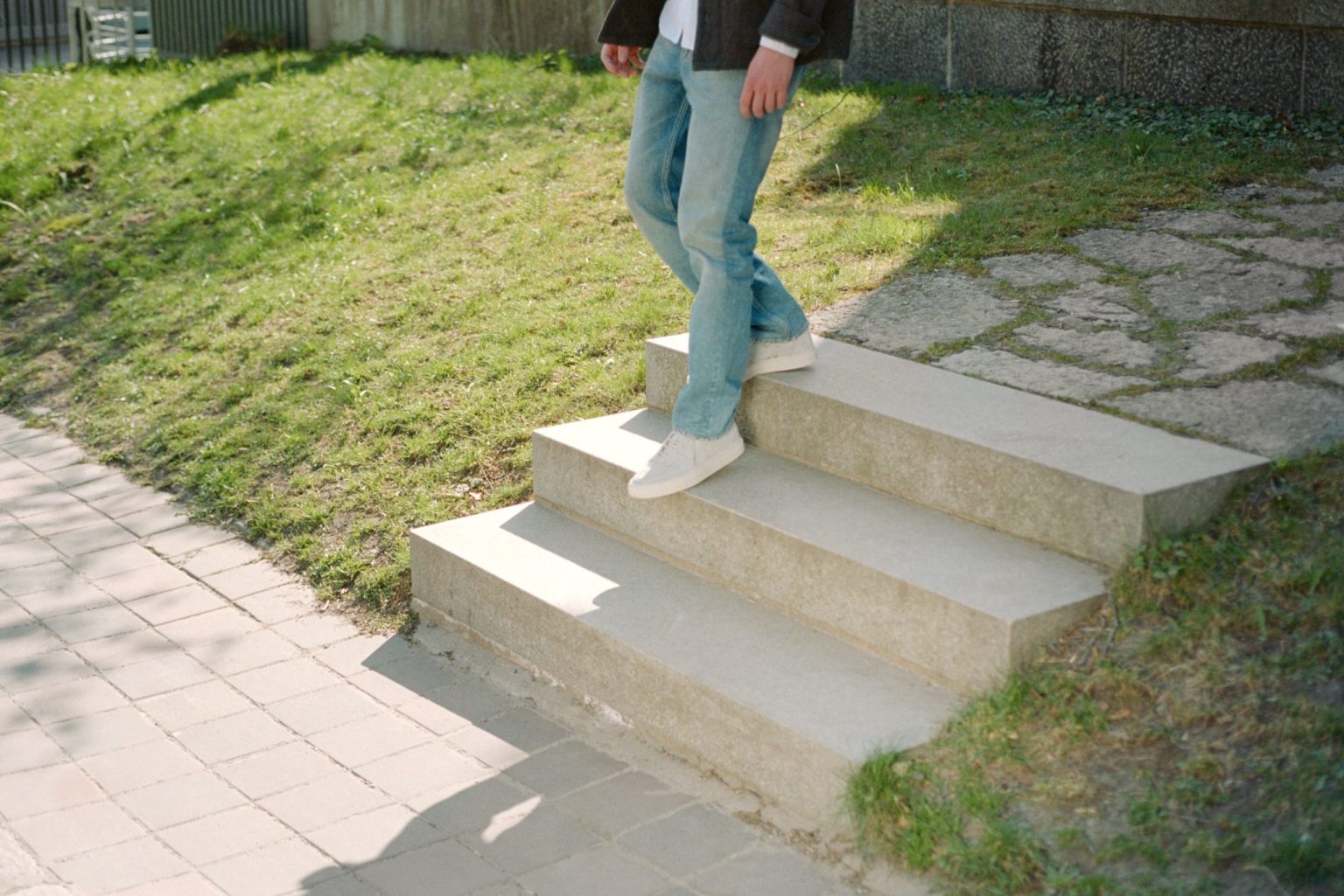 a person walking up a set of concrete stairs