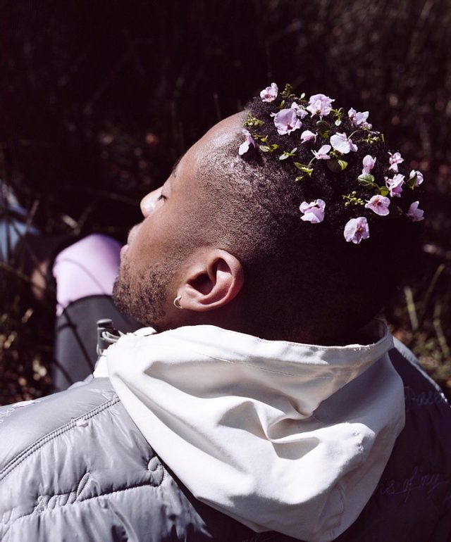 a man with flowers in his hair