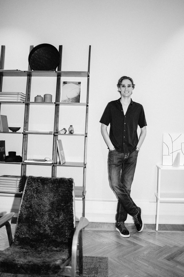 a man standing in front of a shelf