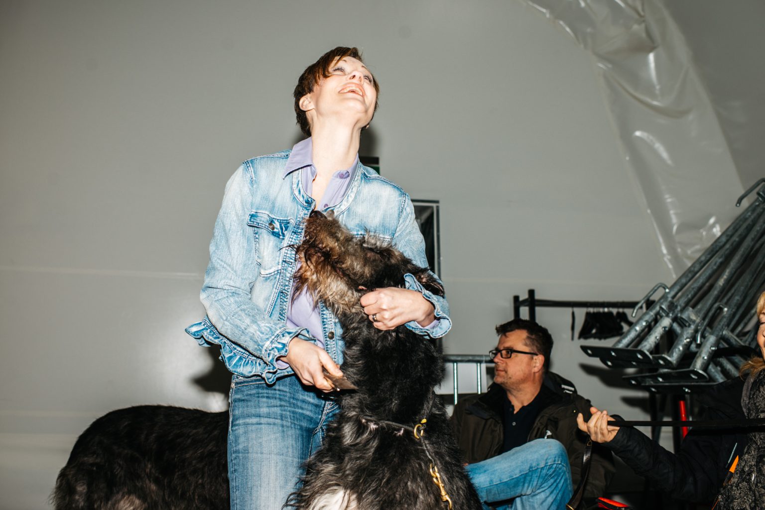 a woman holding a dog