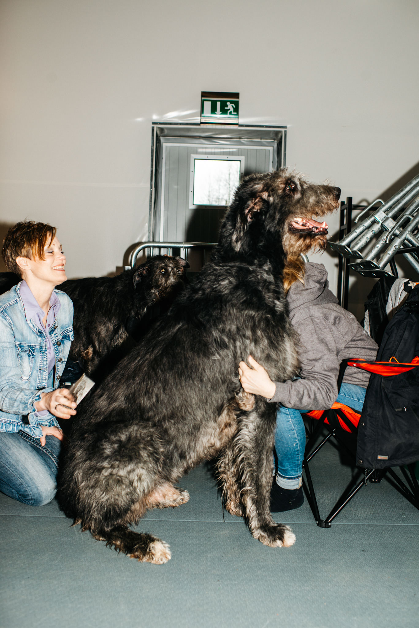 a woman sitting with a large dog