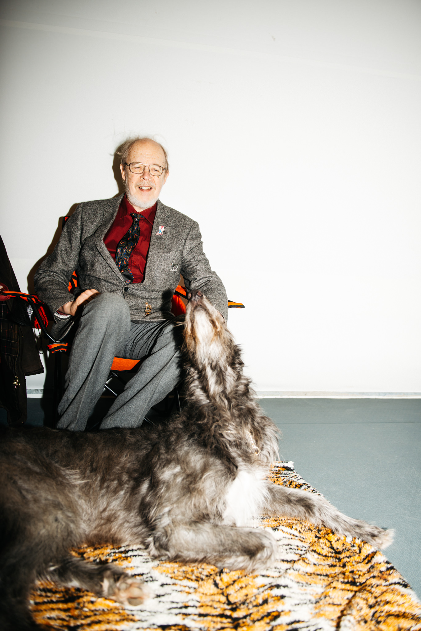 a man sitting in a chair with a dog