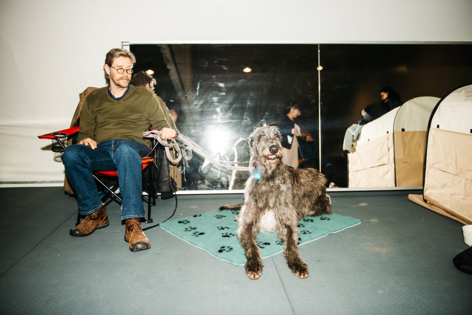 a man sitting in a chair with a dog