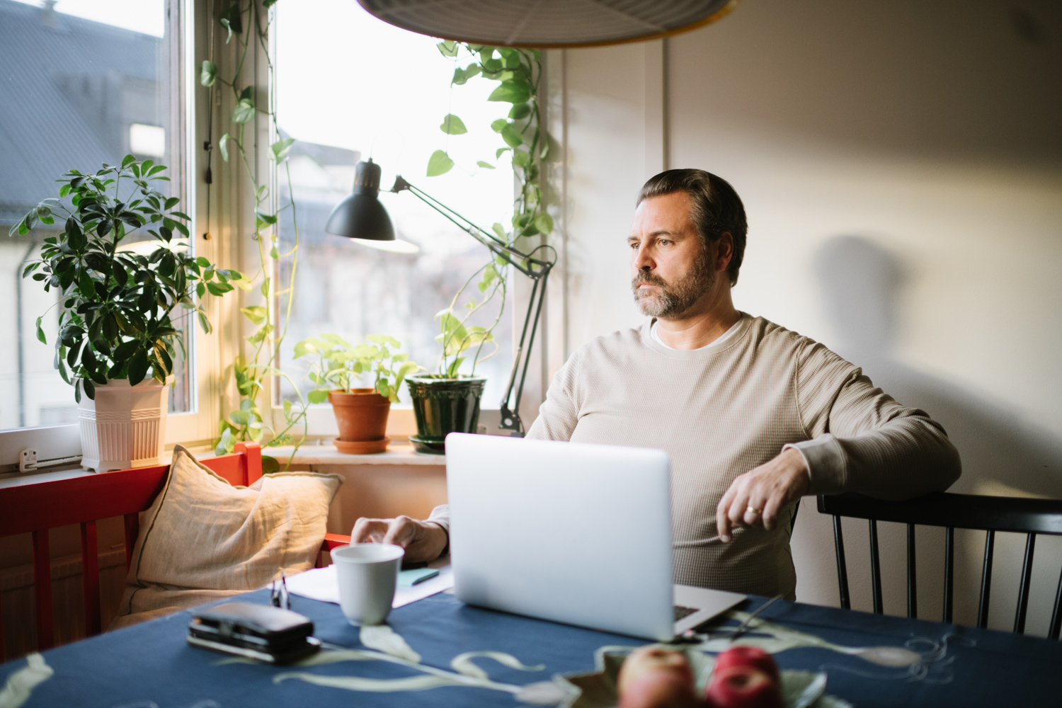 a man sitting at a table with a laptop