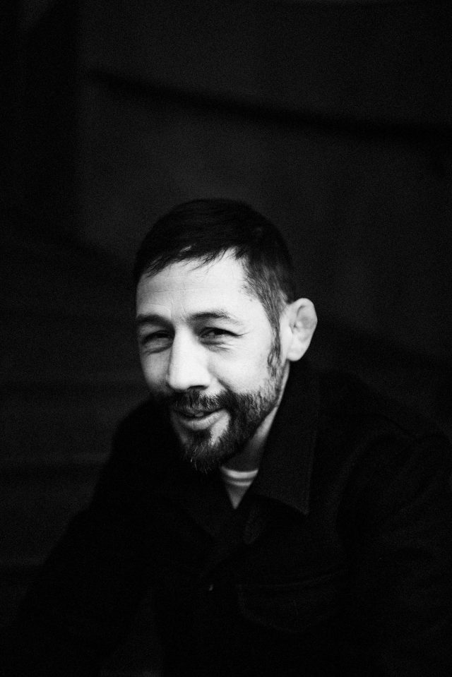 a man with a beard smiling