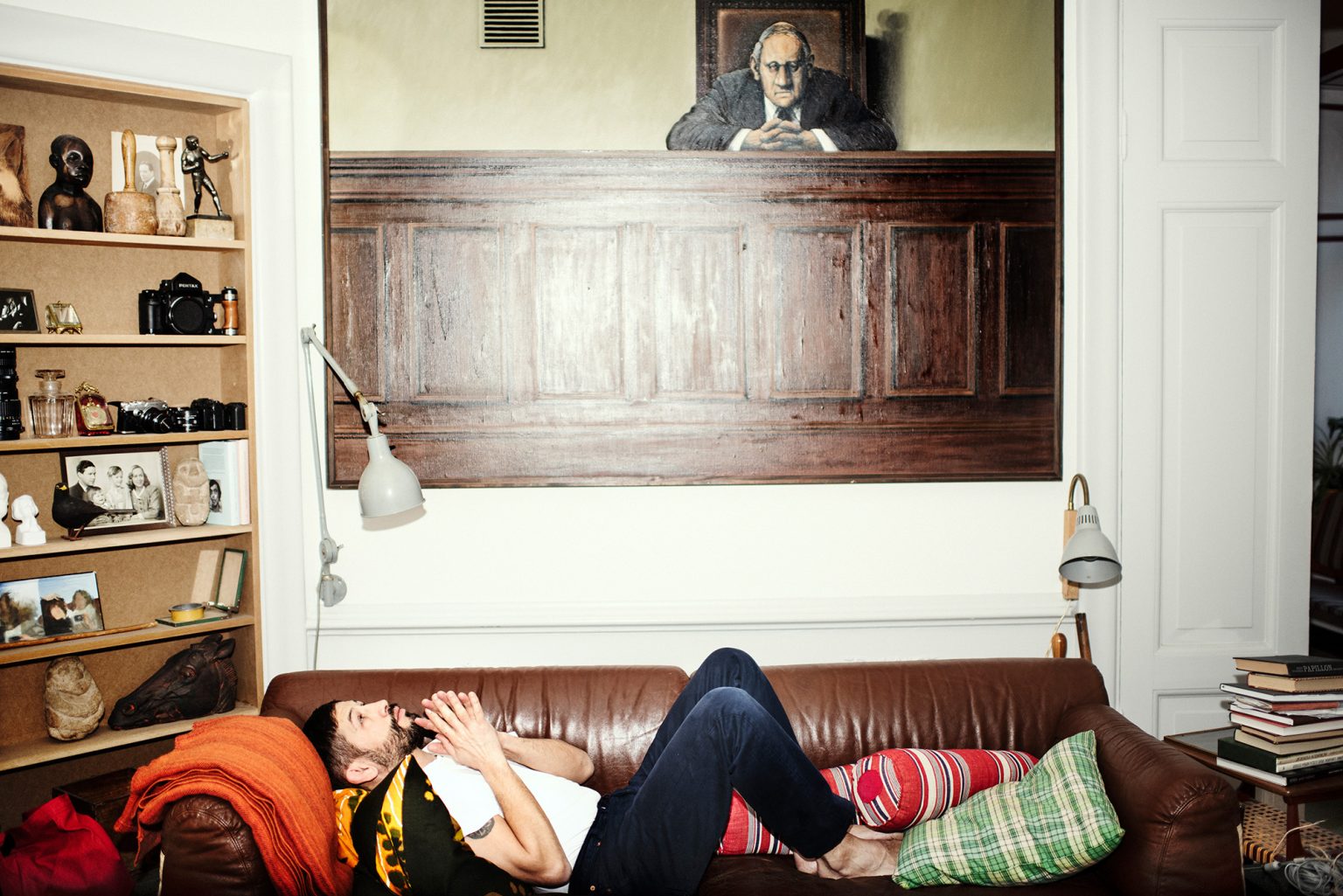 a man lying on a couch with his mouth open