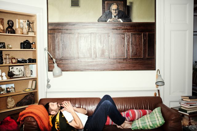 a man lying on a couch with his mouth open