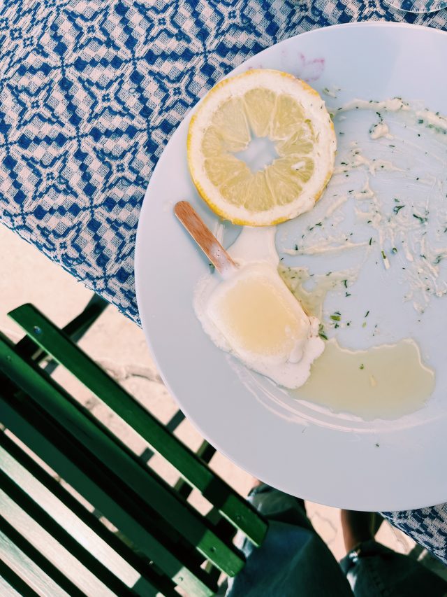 a plate with a lemon and ice cream on it