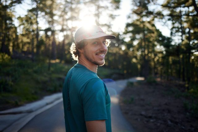 a man smiling in a hat