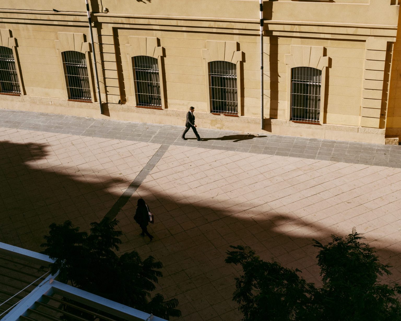 a man walking in a courtyard