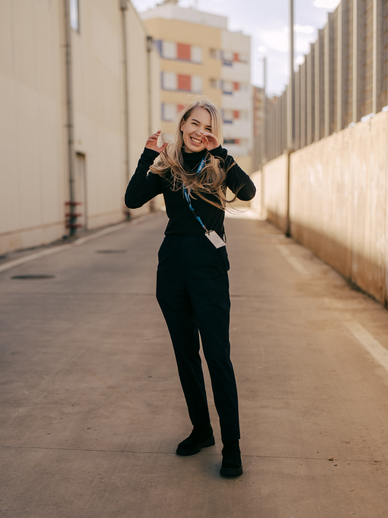 a woman smiling in a street