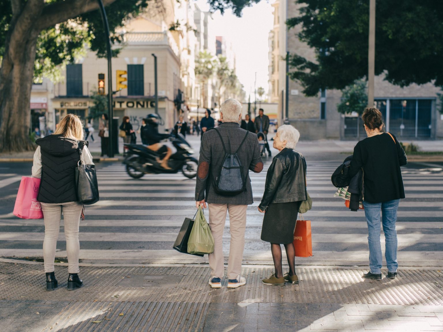 a group of people standing on a crosswalk