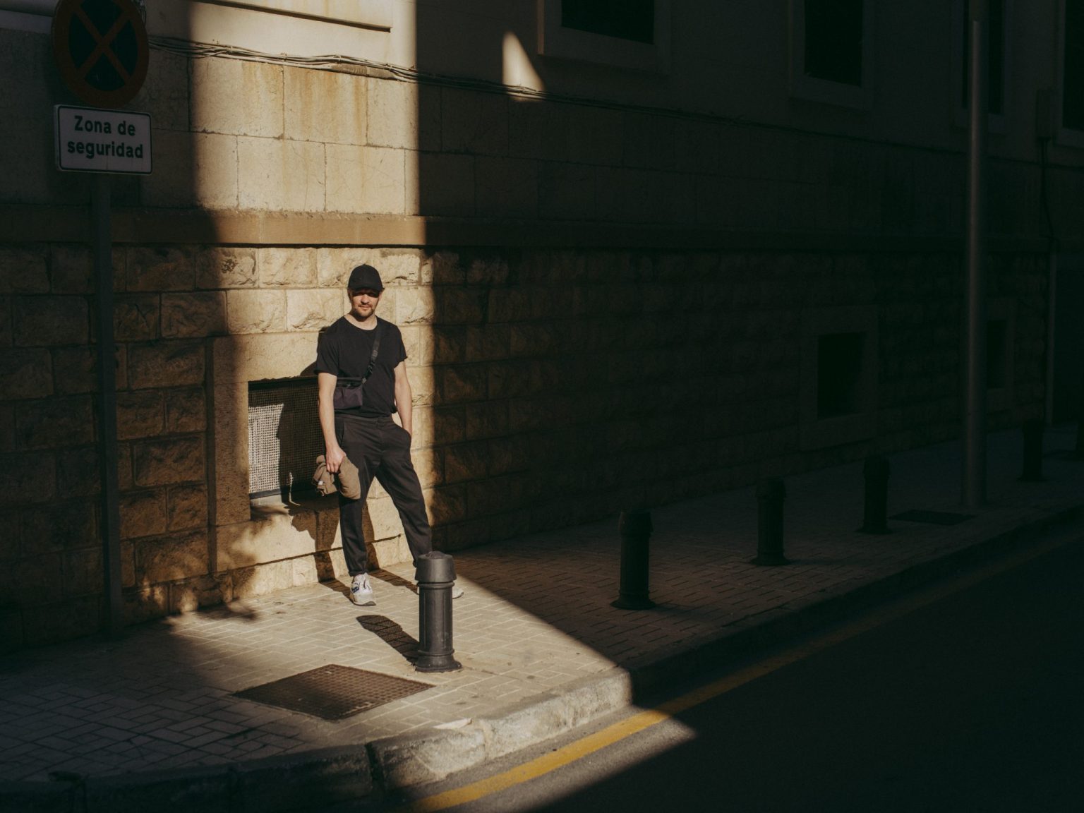 a man standing on a sidewalk