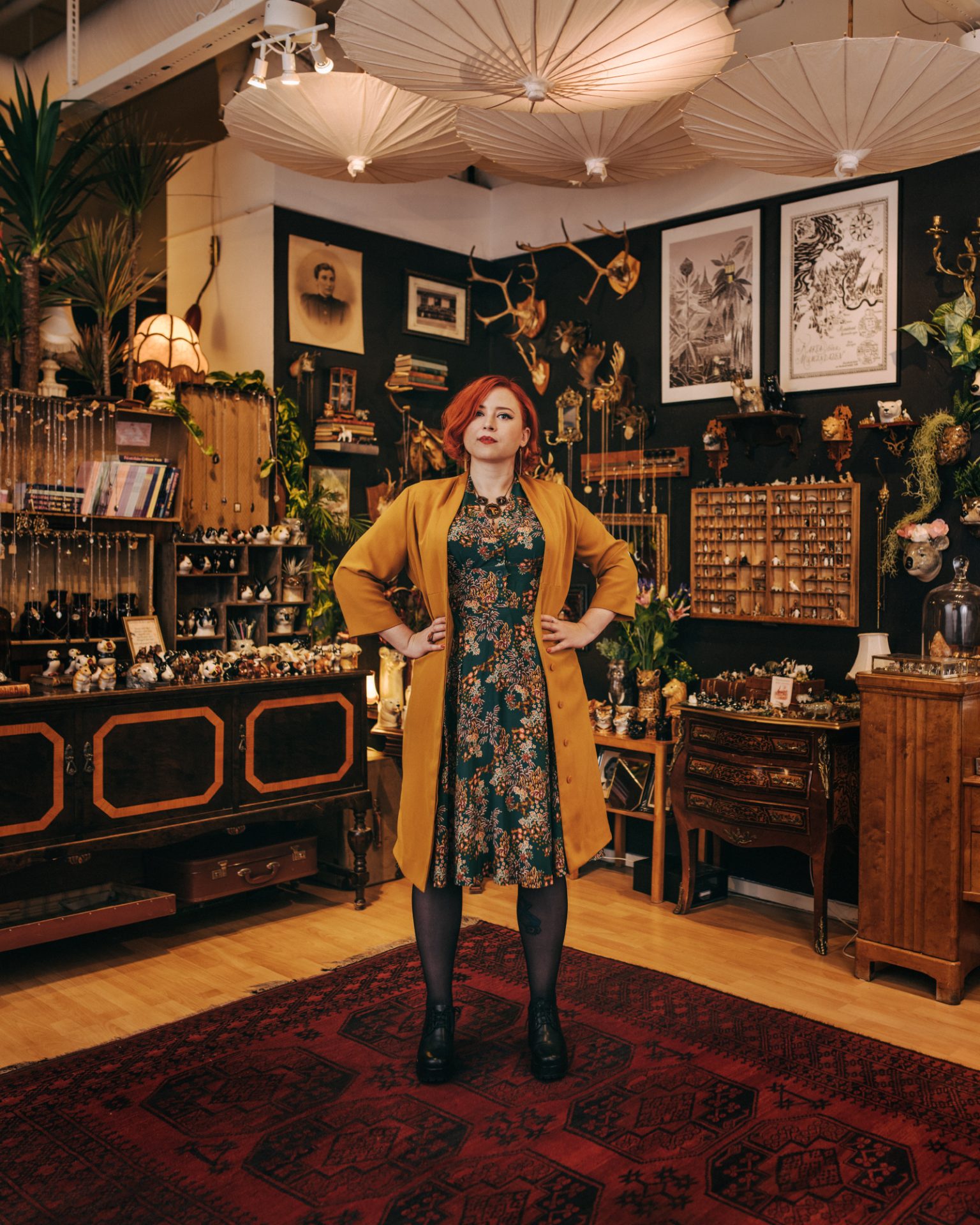 a woman standing in a room with a variety of objects
