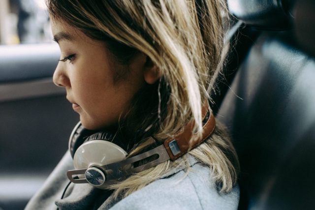 a woman with headphones around her neck