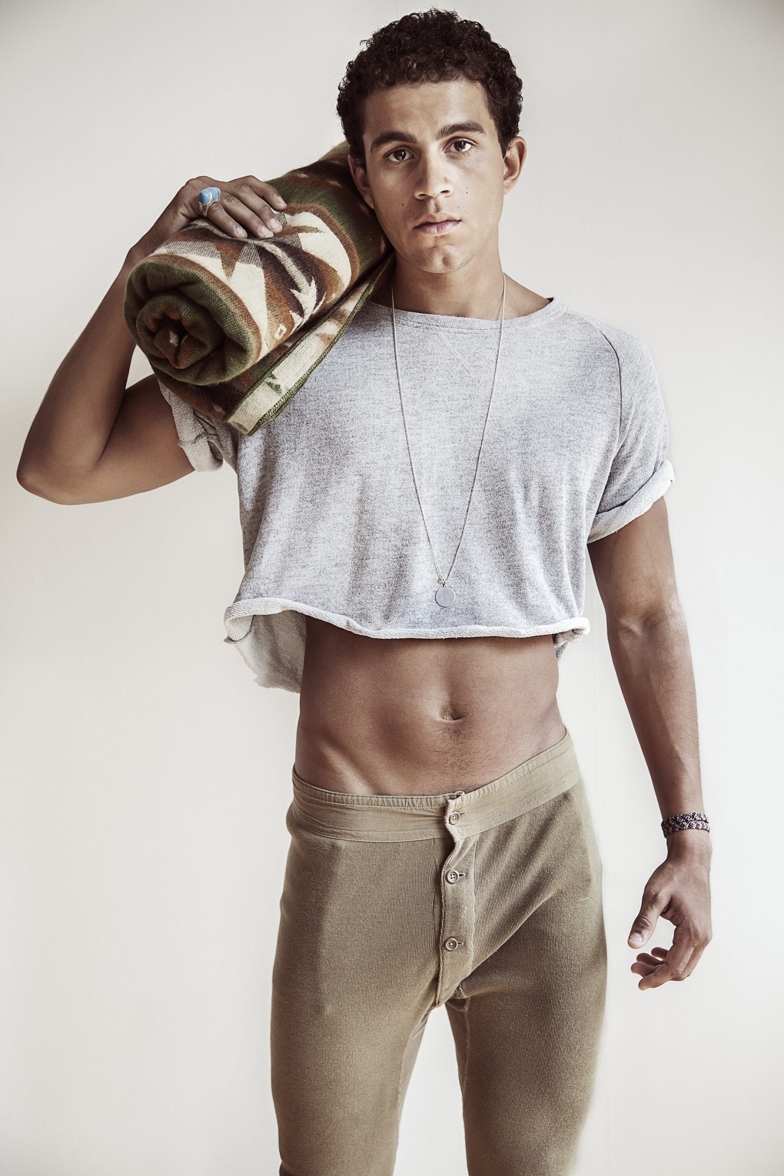 a man holding a rug on his shoulder