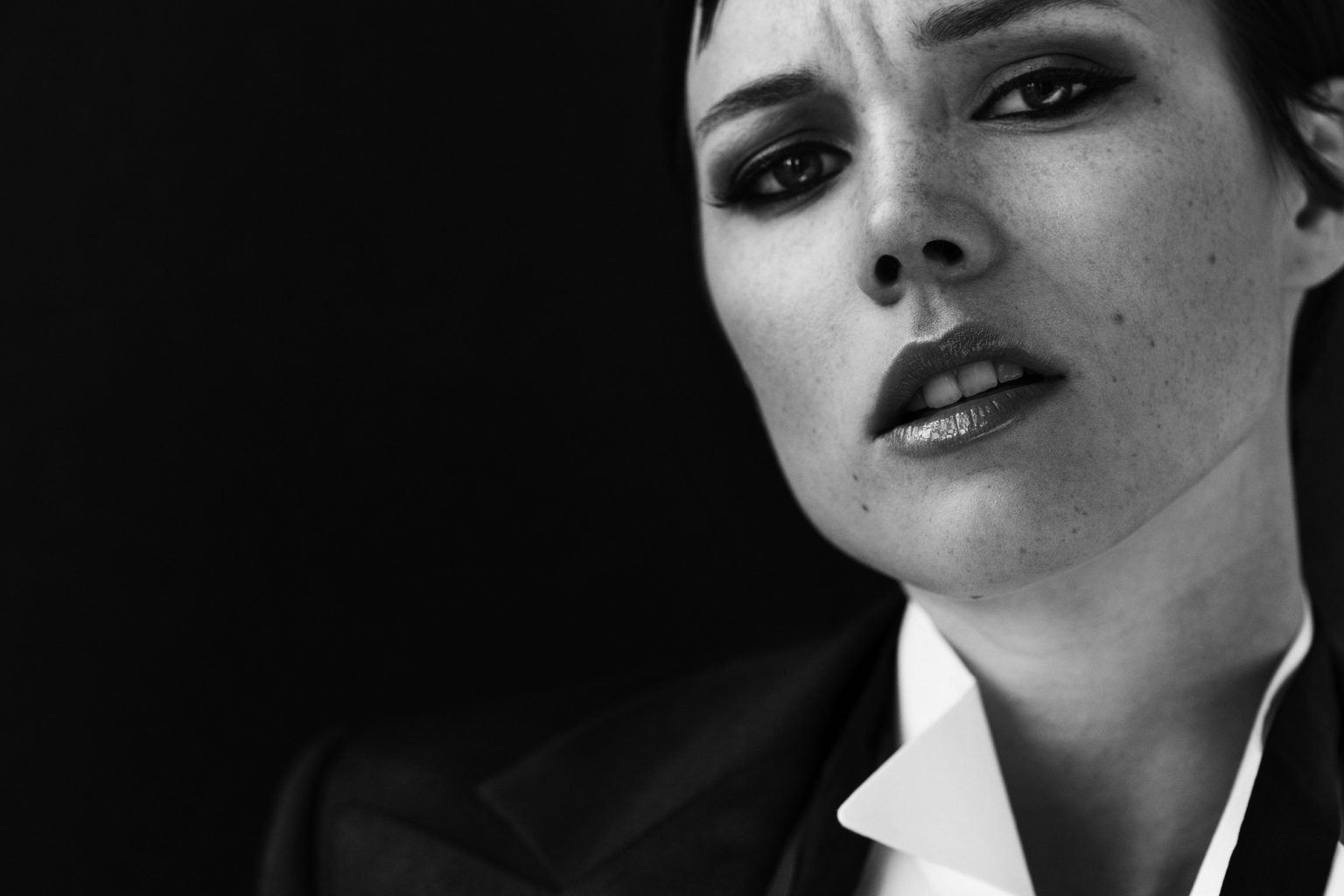 a woman with dark makeup and a black jacket