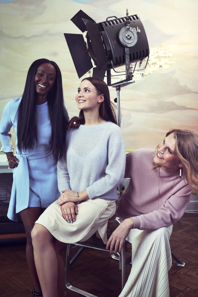 a group of women sitting in front of a spotlight