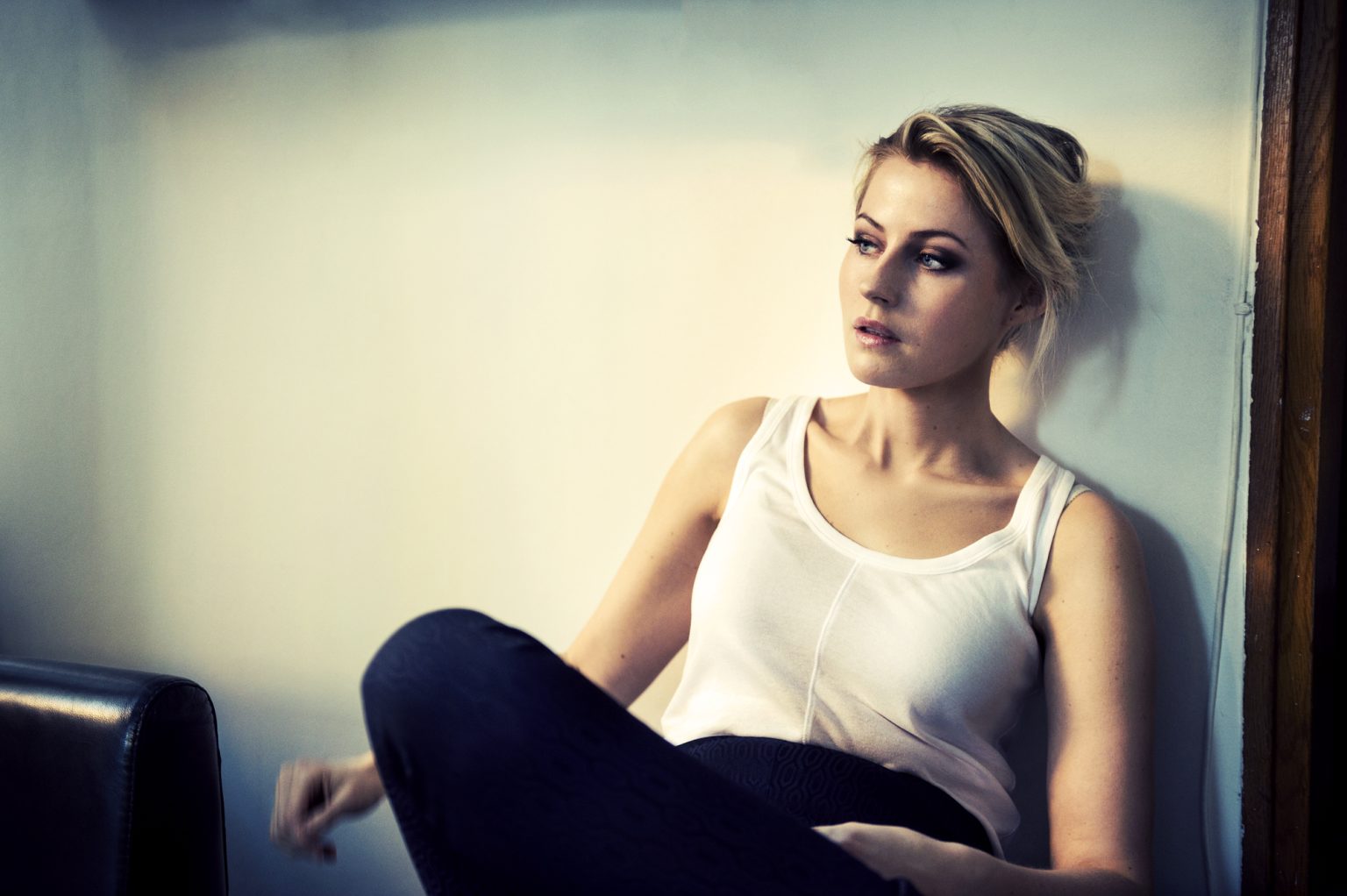 a woman sitting on a wall
