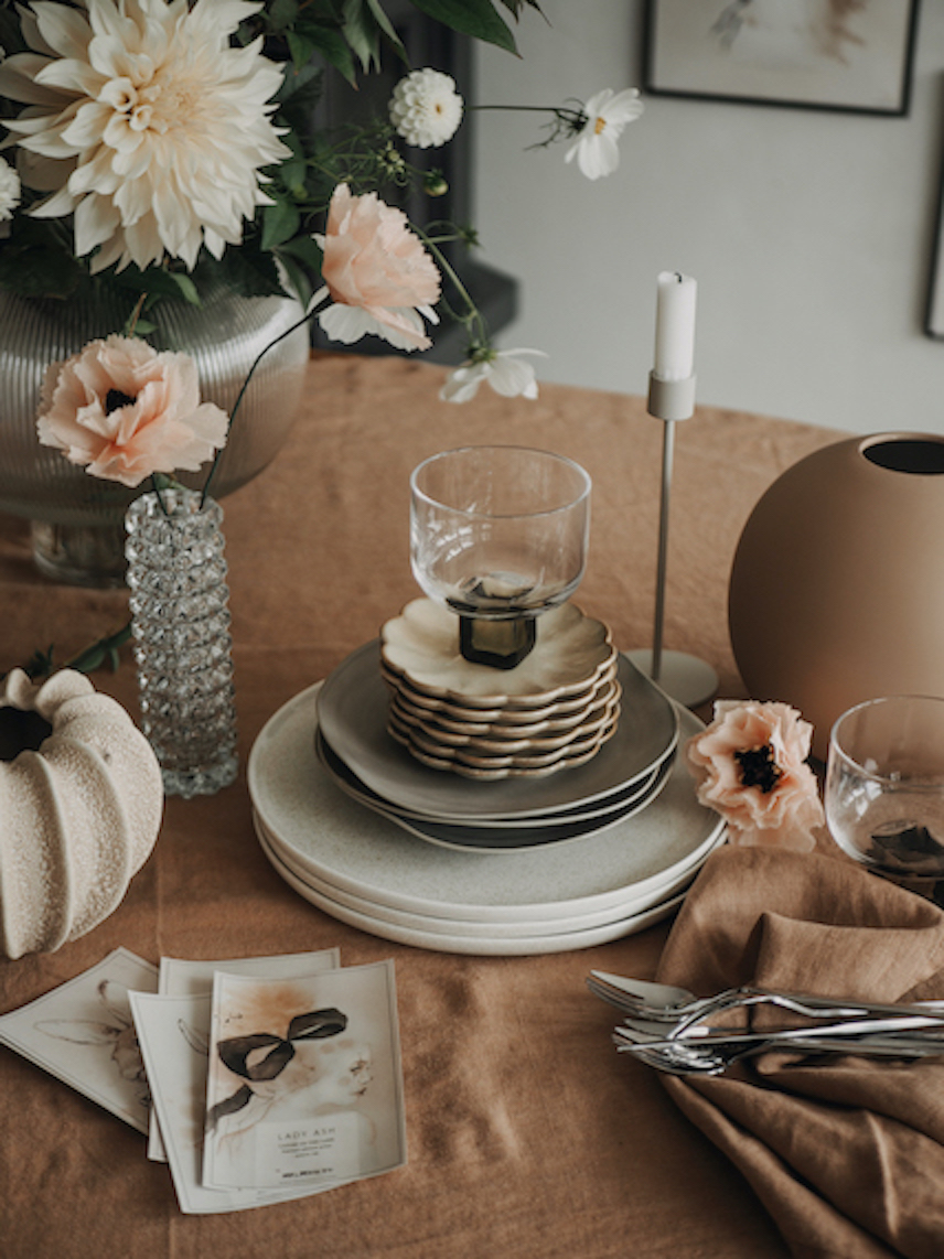 a stack of plates and glasses on a table