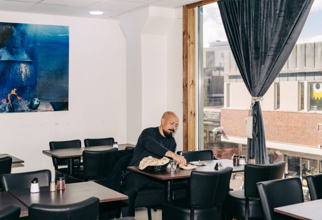 a man sitting at a table eating