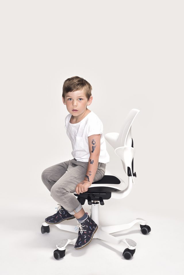 a boy sitting on a chair