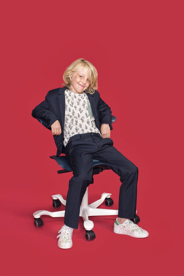 a boy sitting on a chair