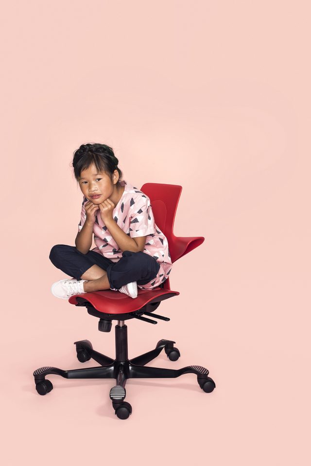 a girl sitting on a chair