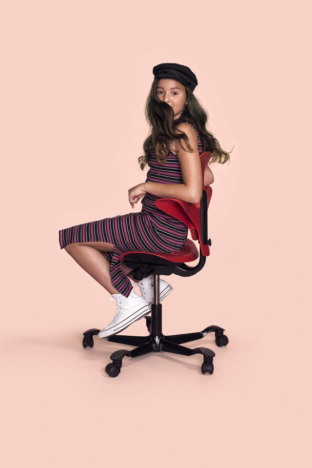 a girl sitting on a chair