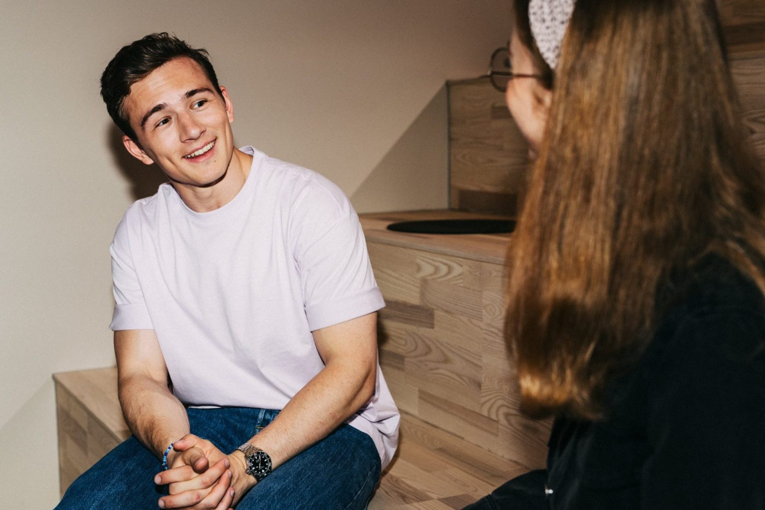 a man sitting on the floor and smiling
