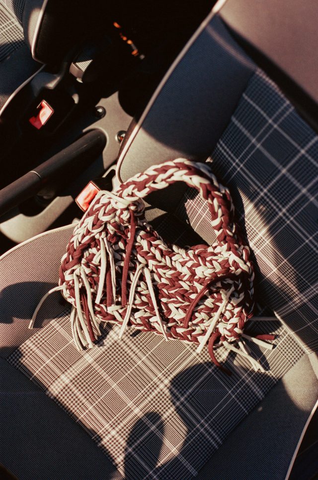 a knitted purse on a seat