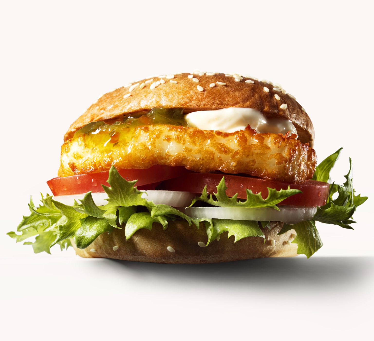 a burger with lettuce and meat patties