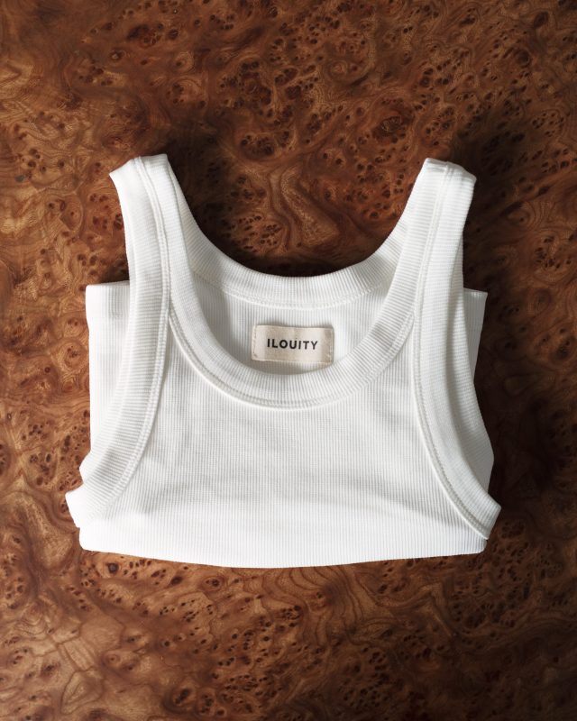 a white tank top on a wood surface