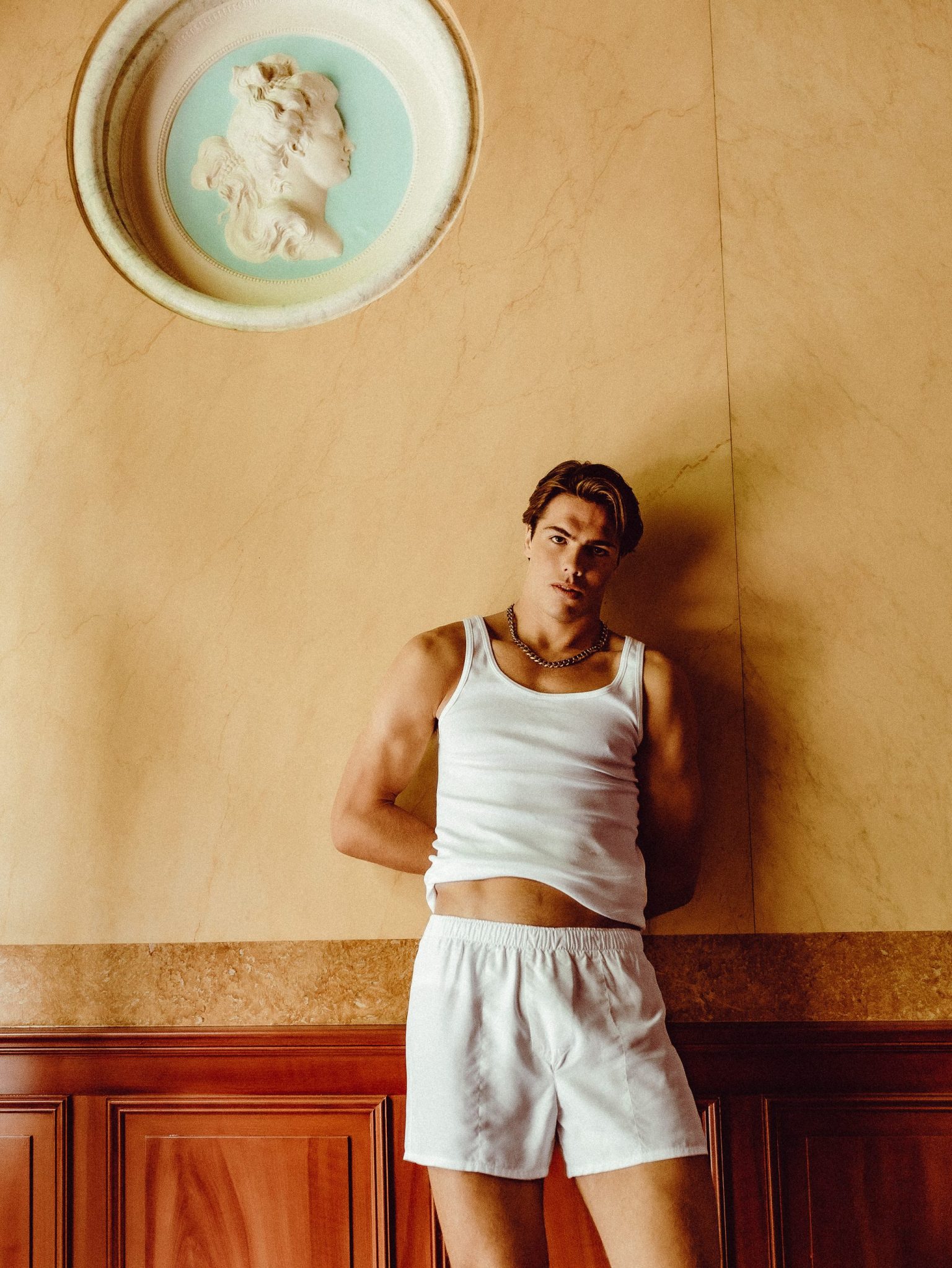 a man leaning against a wall