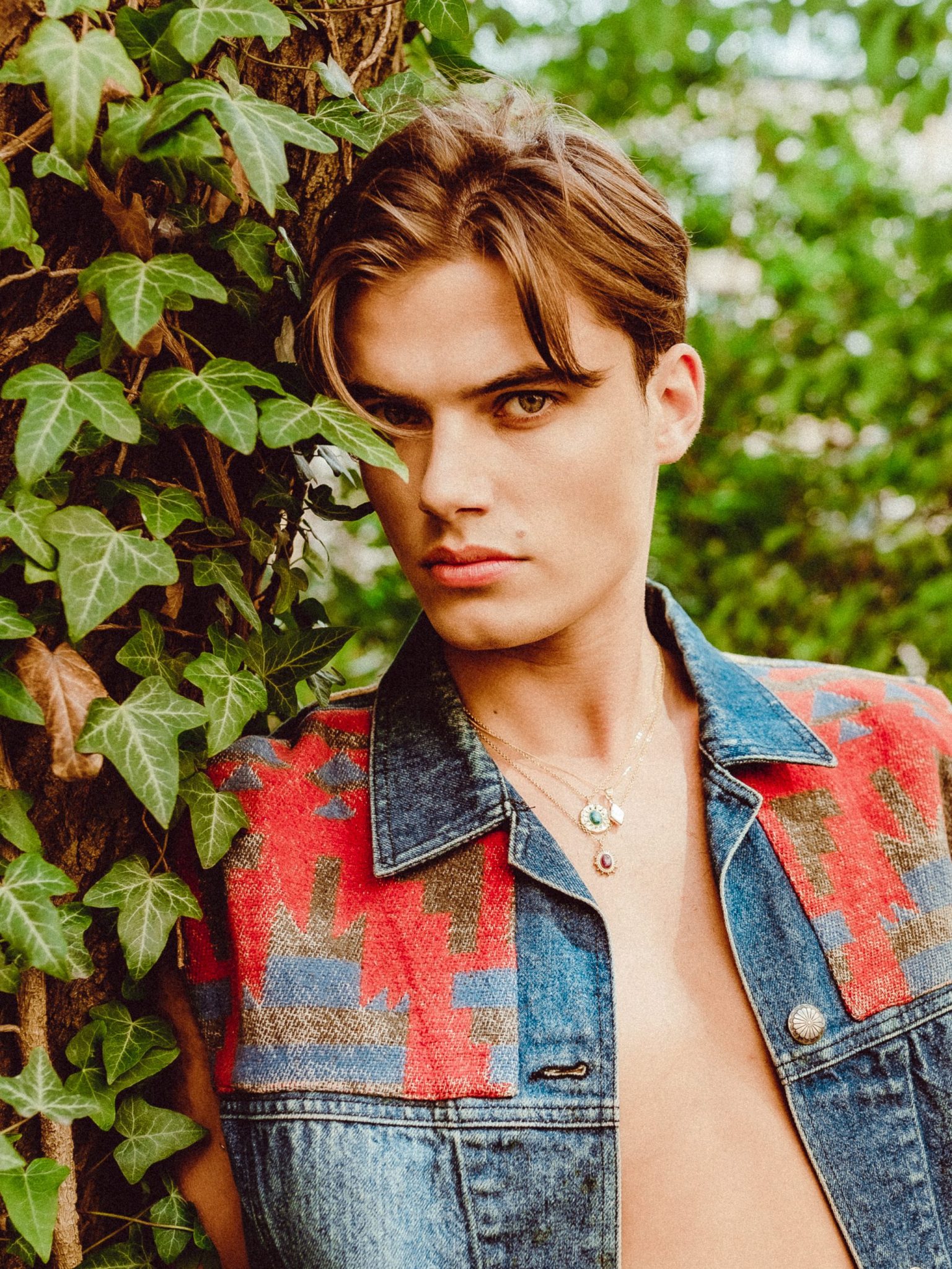 a man standing next to a tree