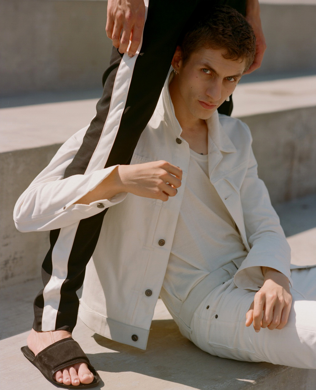 a man sitting on a step with a woman holding his arm around him