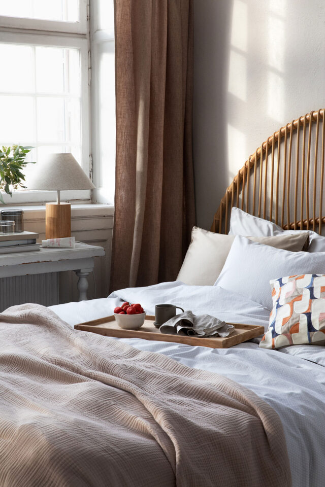 a bed with a tray of food on it
