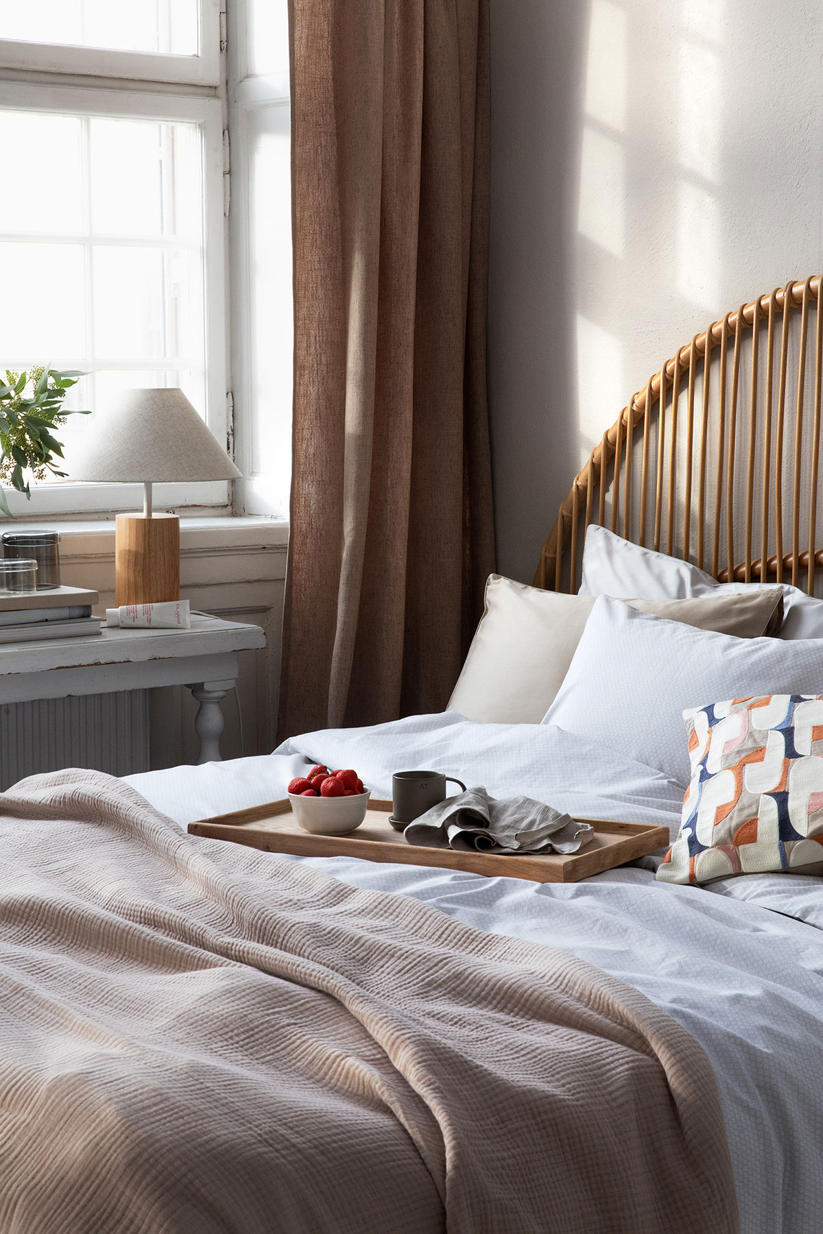 a bed with a tray of food on it
